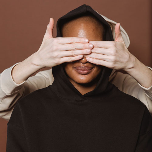 A woman with closed eyes and a thoughtful expression