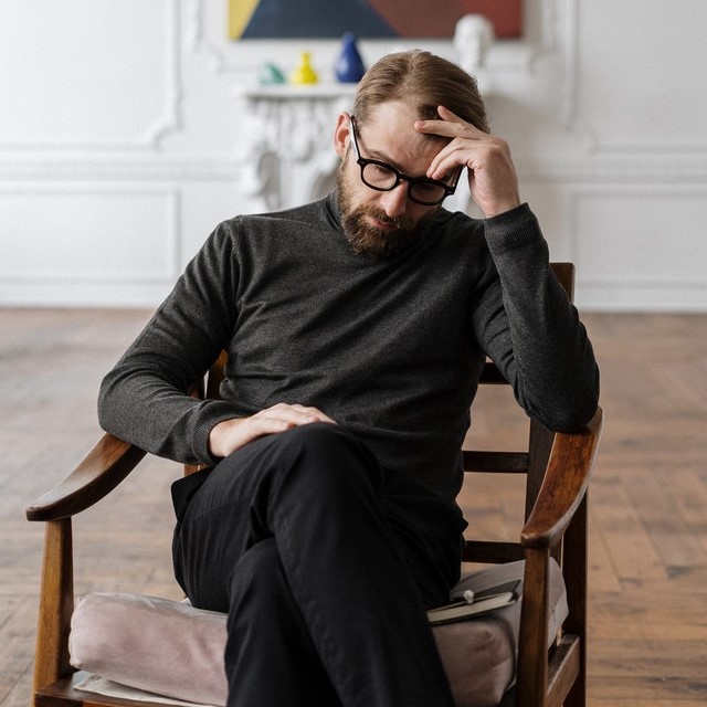 Worrier personality sitting on a bench with a troubled expression